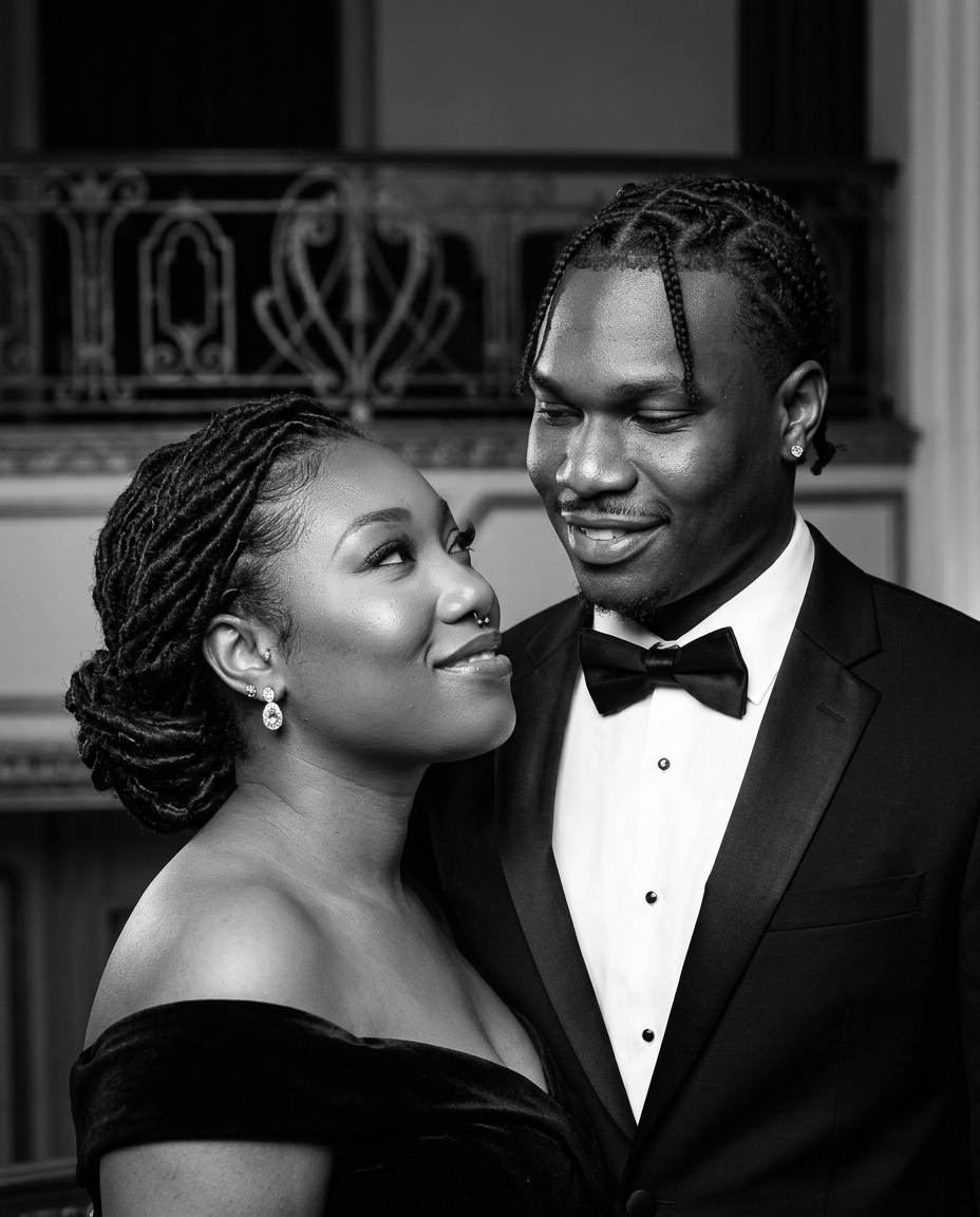 Newly generated black-and-white portrait of Jakki and Clyde sharing a quiet smile at a theater balcony